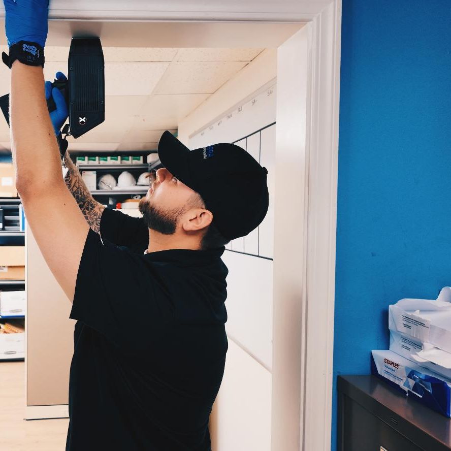 TERRA technician scanning a wall with an XRF analyzer during a lead-based paint survey