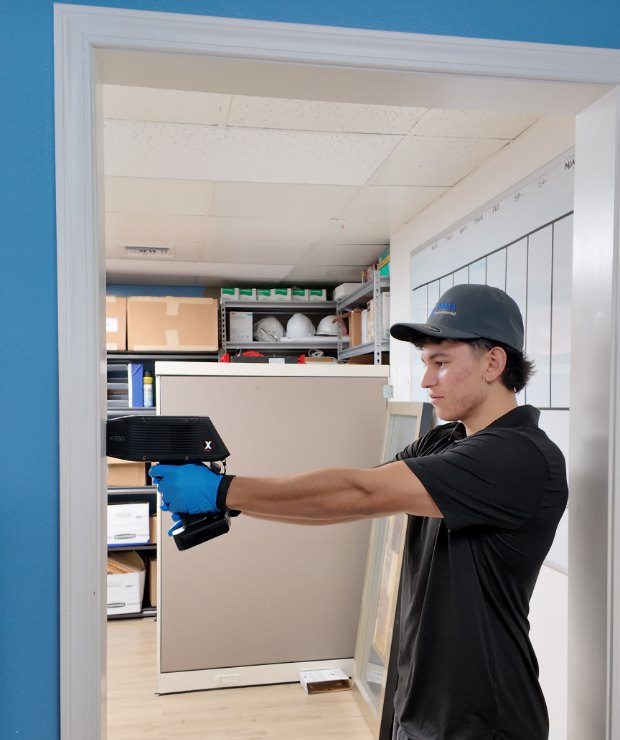 TERRA technician performing an XRF lead survey in an occupied office